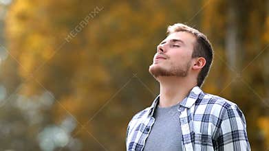 Man breathing in a park in autumn