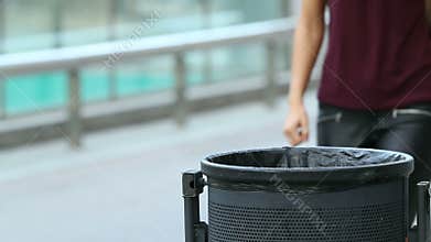 Girl throwing a paper into bin