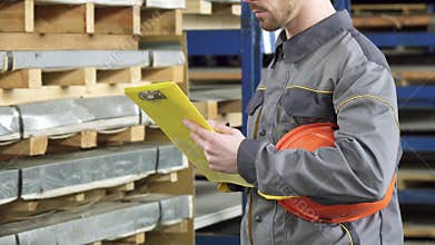 Cropped shot of a warehouse worker checking inventory in stock