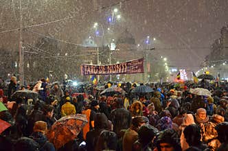 Anti government protests in Bucharest in inclement weather.