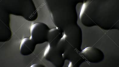 Black oil droplets close up falling down slow motion