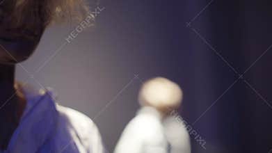 Girl in futuristic costume is dancing at the nihgtclub` s scene