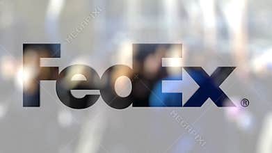 FedEx logo on a glass against blurred crowd on the steet. Editorial 3D rendering