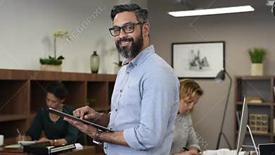 Matured mixed race business man using digital tablet