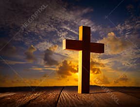 Christian wood cross on sunset sky
