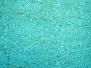 Light blue turquoise stone texture with a cracked irregular granular textured surface with an uneven distressed conglomeration sur