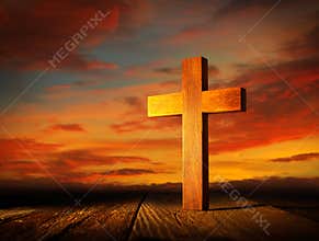 Christian wood cross on sunset sky