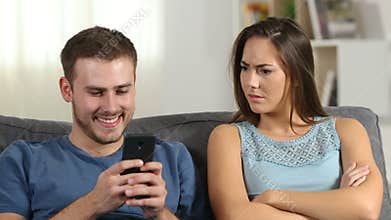 Jealous wife scolding her husband who is using phone