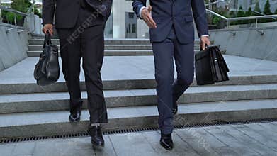 Colleagues going together near business center, attorneys discussing court case