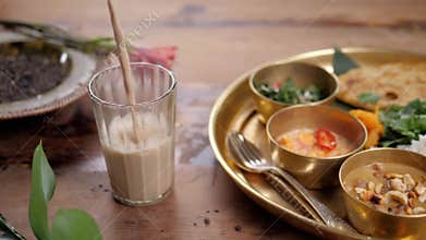 Beautiful and homemade fresh Indian sri lankian drink - mango lassi. On wooden table, garnished with fresh mint. Natural