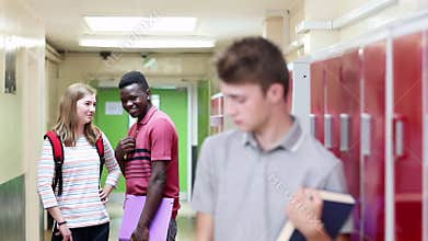 Unhappy Male High School Student Talked About By Students In Corridor