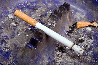 Cigarette in Dirty Ash Tray
