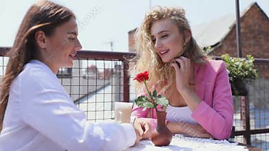Beautiful women meeting at cafe outdoors