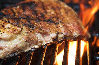Flaming barbecue ribs on a grill