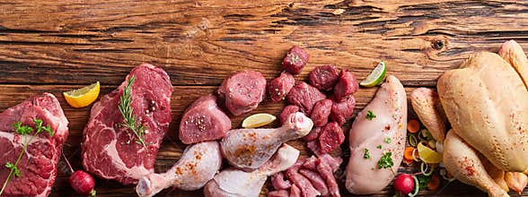 Assortment of raw meat on wooden table