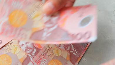 Hand counting new zealand banknote banking and financial theme