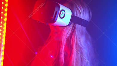 Young woman wearing VR headset .