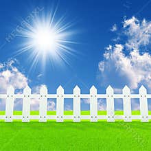 White fence on a summer lawn