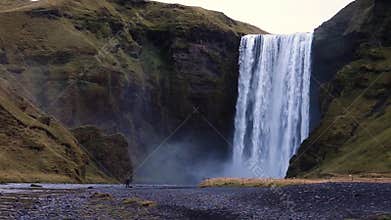 Iceland waterfall on the background of mountains. Streams of water fall from the cliff and fall down.