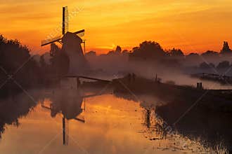 Sunrise heats up the canal water into the mist