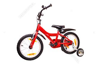 New red children's bicycle on white