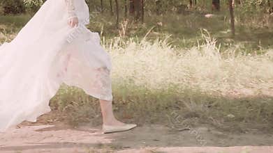 Running bride in the forest escapes from the monster and killer. escaped young attractive girl in elegant white vintage