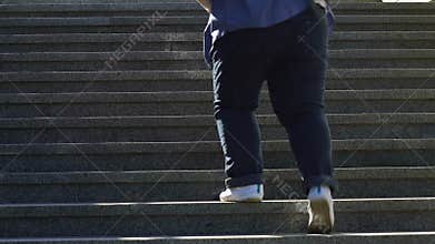 Overweight man climbing stairs, suffering dyspnea, problems with health, obesity