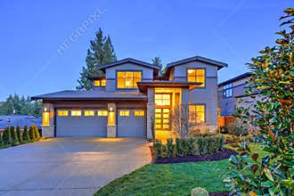 Grey luxury modern two story tall house exterior with stone columns