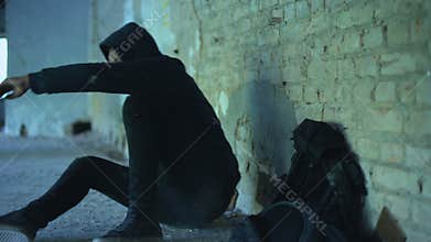 Afro-american teenager hiding from bullying in abandoned building, racism