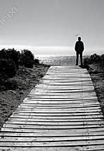 Silhouette man on beach path