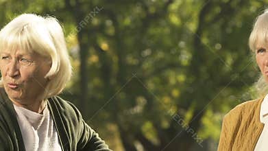 Old women talking outside, judging people passing by, old age rumor, gossips