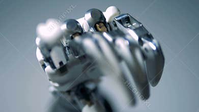Person touches robotic hand, close up.