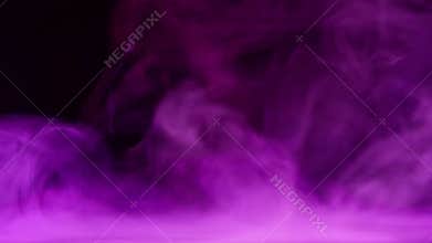 Purple smoke waves over calm water