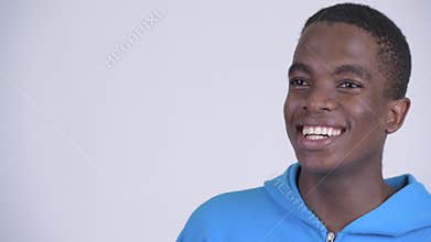 Face of young happy African man smiling and thinking
