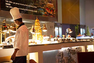Chef and assistant Chefs cooking and prepared buffet food at restaurant in night time in Bangkok, Thailand