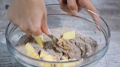 Cutting butter into flour to make Pastry Dough.
