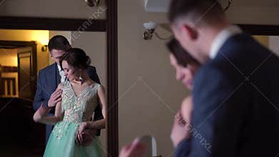 Beautiful newlywed couple posing in the chic expensive indoor.