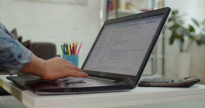 Hands of programmer working with computer in office