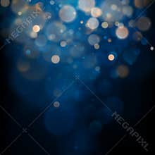 Blurred bokeh light on dark blue background. Christmas and New Year holidays template. Abstract glitter defocused