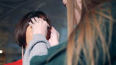 One woman works with humanoid robot, close up.