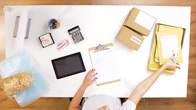 Woman processing fragile parcels at post office