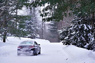 Car drives on snowy road