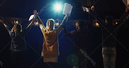 Actors bowing to audience in a theater