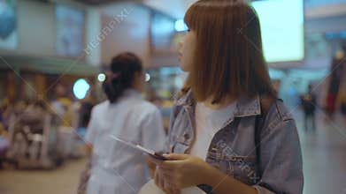Slow motion - Happy Asian woman using trolley or cart with many luggage walking in terminal hall.
