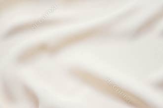 Matte cream soft pleated fabric background. Smooth elegant luxury cloth texture. Gentle pastel color wedding background