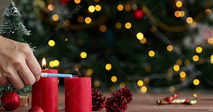 Someone hand light candle.