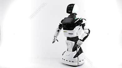 Modern Robotic Technologies. Robot in the bright studio. Android raises and lowers hands on a white background. Waving a