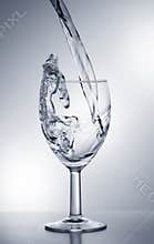 Water falling into glass