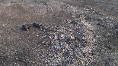 Environmental pollution problem, drone view on people work at dump near trucks and flying seagulls over large rubbish