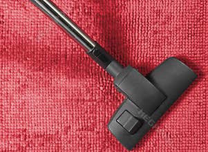 Vacuum Cleaner on a Red Rug